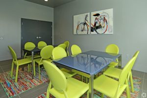 community room with tables and neon green chairs
